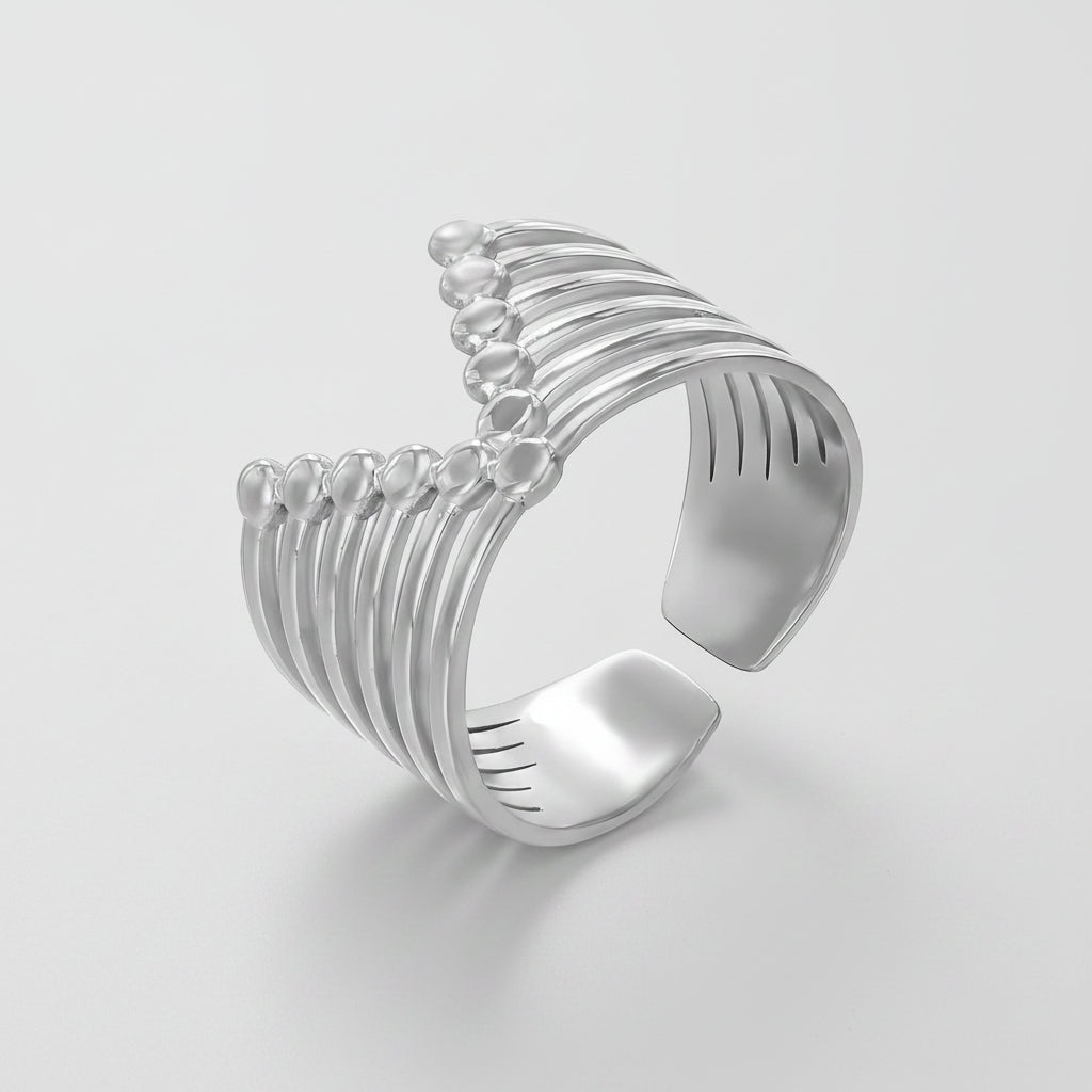 Futuristic stainless steel ring with layered slim bands and polished silver bead accents in an open cuff style