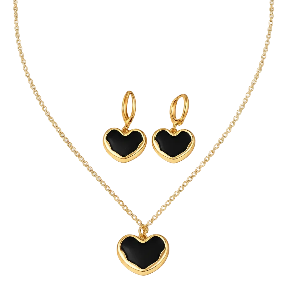 Gold heart-shaped jewelry set with black stones on a light gray background