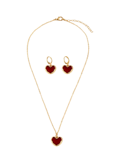Jewelry set with heart-shaped pendants on a gold chain and earrings.