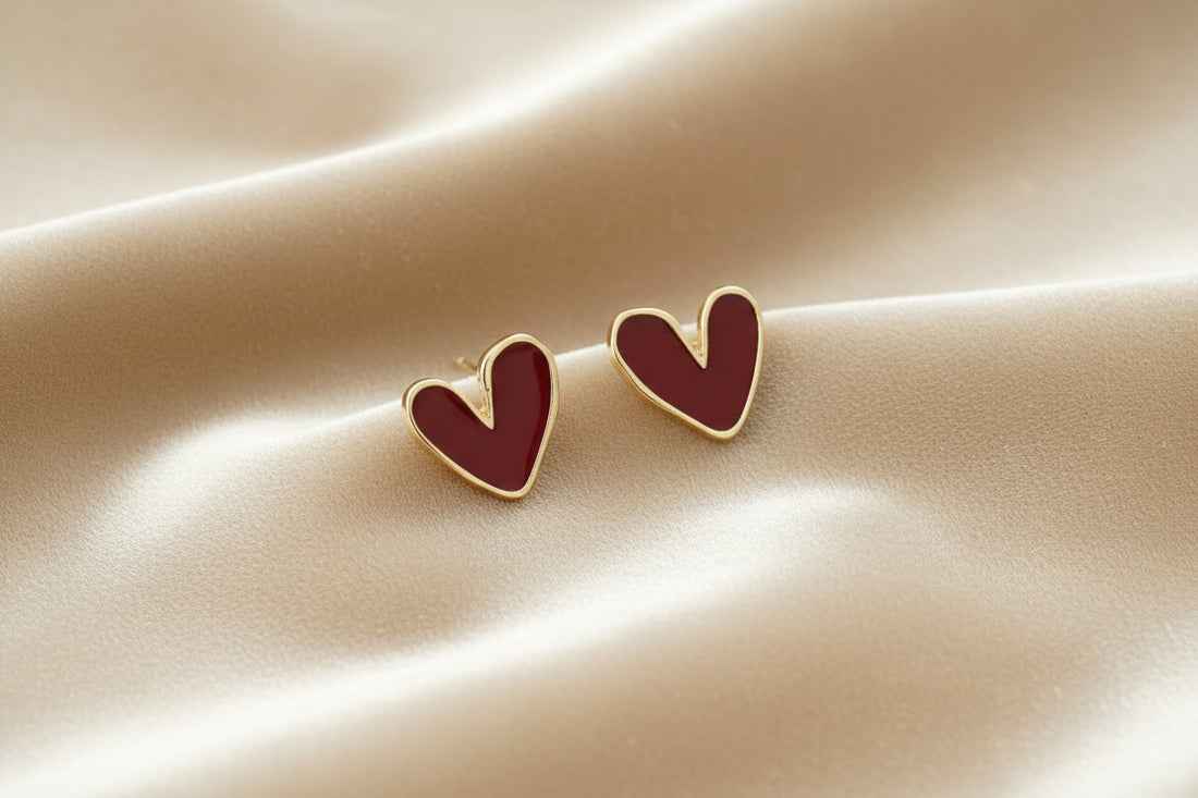 Heart-shaped earrings on a beige fabric background