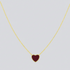 Gold necklace with a red heart pendant on a light gray background