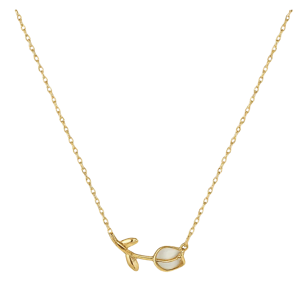 Gold necklace with a leaf and pearl pendant on a white background